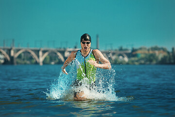 Image showing Professional triathlete swimming in river\'s open water