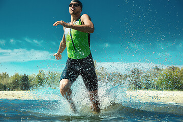 Image showing Professional triathlete swimming in river\'s open water