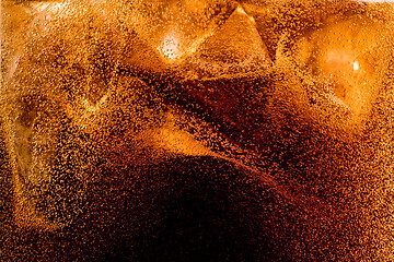 Image showing Close up view of the ice cubes in dark cola background