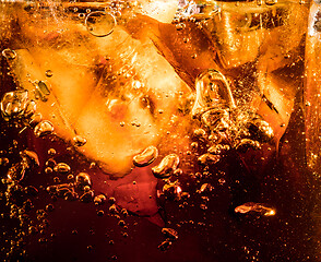 Image showing Close up view of the ice cubes in dark cola background