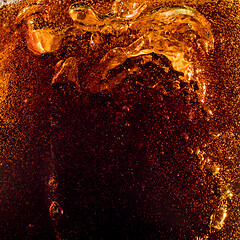 Image showing Close up view of the ice cubes in dark cola background