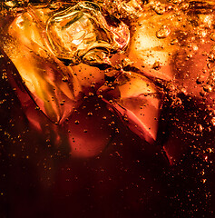 Image showing Close up view of the ice cubes in dark cola background