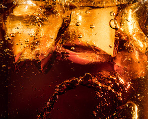 Image showing Close up view of the ice cubes in dark cola background