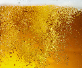 Image showing Close up view of floating bubbles in light beer texture