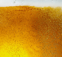 Image showing Close up view of floating bubbles in light beer texture