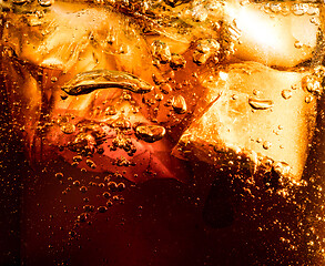 Image showing Close up view of the ice cubes in dark cola background