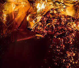 Image showing Close up view of the ice cubes in dark cola background