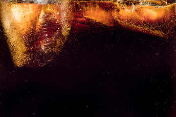 Image showing Close up view of the ice cubes in dark cola background