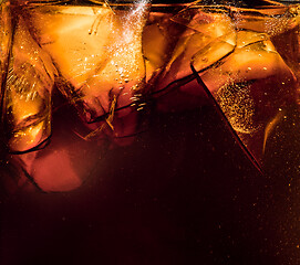 Image showing Close up view of the ice cubes in dark cola background