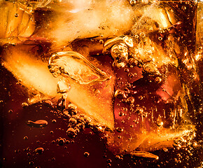 Image showing Close up view of the ice cubes in dark cola background