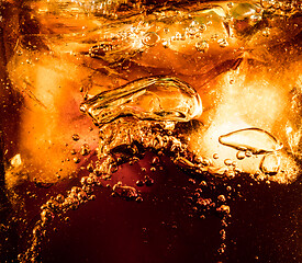 Image showing Close up view of the ice cubes in dark cola background