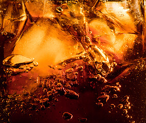 Image showing Close up view of the ice cubes in dark cola background