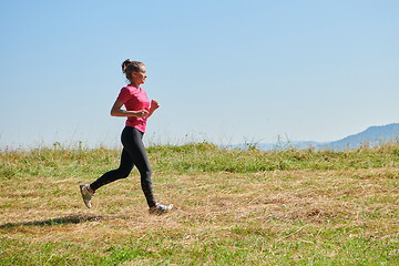 Image showing woman enjoying in a healthy lifestyle while jogging