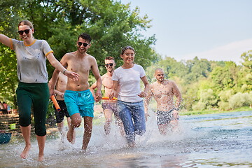 Image showing group of happy friends having fun on river