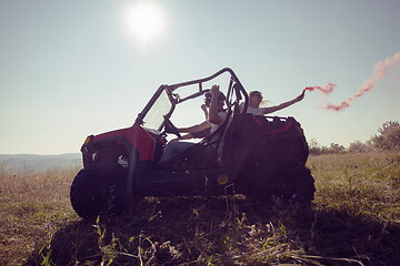 Image showing  colorful torches while driving a off road buggy car