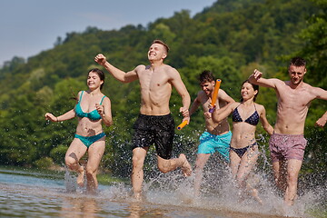 Image showing group of happy friends having fun on river