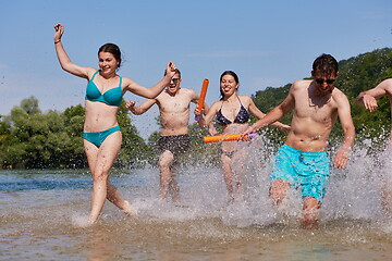 Image showing group of happy friends having fun on river