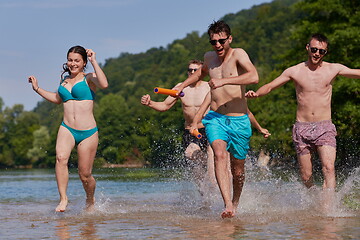 Image showing group of happy friends having fun on river