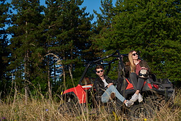 Image showing couple enjoying beautiful sunny day while driving a off road buggy