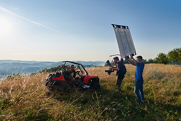 Image showing cameraman recording a young couple enjoying a buggy car ride up a mountain