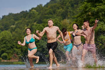 Image showing group of happy friends having fun on river