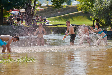 Image showing group of happy friends having fun on river