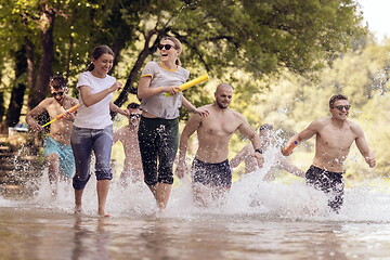 Image showing group of happy friends having fun on river