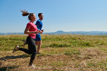 Image showing couple jogging in a healthy lifestyle on a fresh mountain air