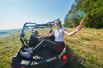 Image showing  colorful torches while driving a off road buggy car