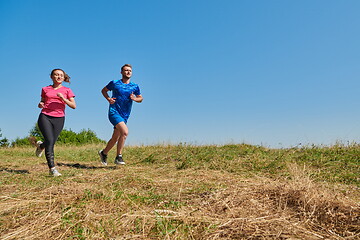 Image showing couple jogging in a healthy lifestyle on a fresh mountain air