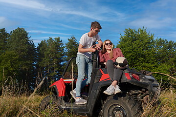 Image showing couple enjoying beautiful sunny day while driving a off road buggy