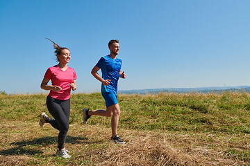 Image showing couple jogging in a healthy lifestyle on a fresh mountain air