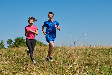 Image showing couple jogging in a healthy lifestyle on a fresh mountain air