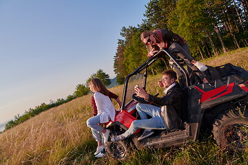 Image showing group young happy people enjoying beautiful sunny day while driving a off road buggy car