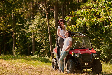 Image showing couple enjoying beautiful sunny day while driving a off road buggy