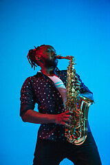 Image showing Young african-american jazz musician playing the saxophone