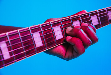 Image showing Young african-american jazz musician playing the guitar