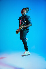 Image showing Young african-american jazz musician playing the saxophone