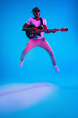 Image showing Young african-american jazz musician playing the guitar