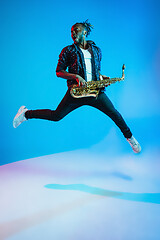 Image showing Young african-american jazz musician playing the saxophone