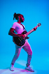 Image showing Young african-american jazz musician playing the guitar