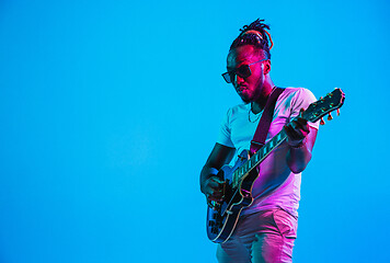 Image showing Young african-american jazz musician playing the guitar