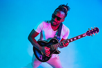 Image showing Young african-american jazz musician playing the guitar