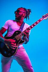 Image showing Young african-american jazz musician playing the guitar