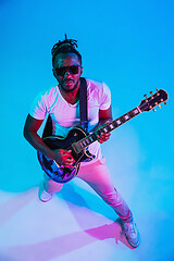 Image showing Young african-american jazz musician playing the guitar