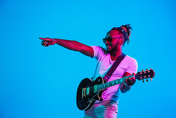 Image showing Young african-american jazz musician playing the guitar