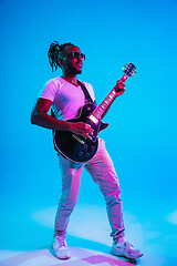 Image showing Young african-american jazz musician playing the guitar