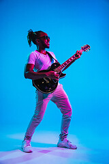 Image showing Young african-american jazz musician playing the guitar