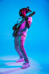 Image showing Young african-american jazz musician playing the guitar