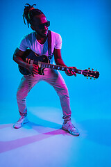 Image showing Young african-american jazz musician playing the guitar